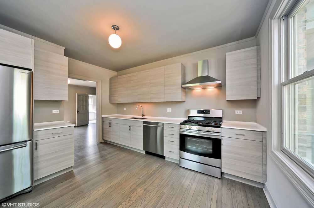 Westover Townhomes beautiful kitchen outfitted with custom cabinetry, quartz countertops, and sleek Samsung stainless steel appliances