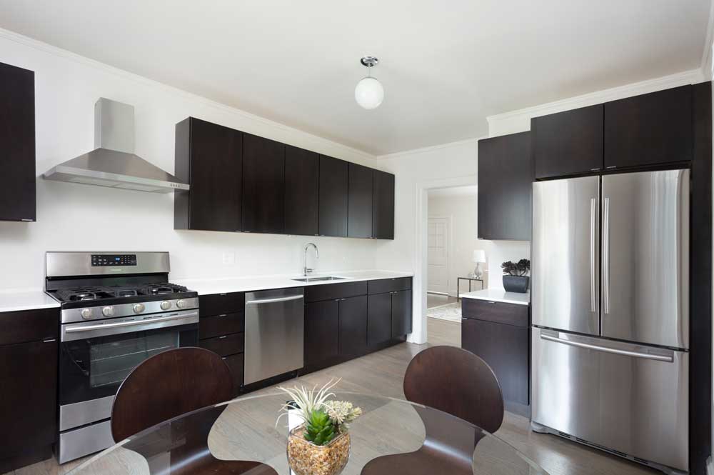 Westover Townhomes beautiful kitchen outfitted with bustom cabinetry, quartz countertops, and sleek Samsung stainless steel appliances